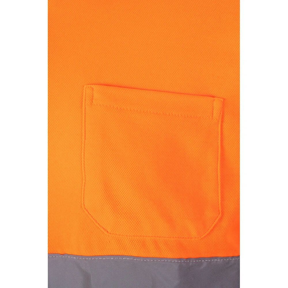 Närbild av orange pikétröja med ficka i kontrasterande grått, perfekt för företagsprofilering.
